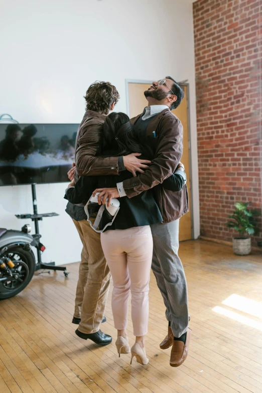 a group of people that are standing in a room, a picture, hugging each other, developers, boston, ignant