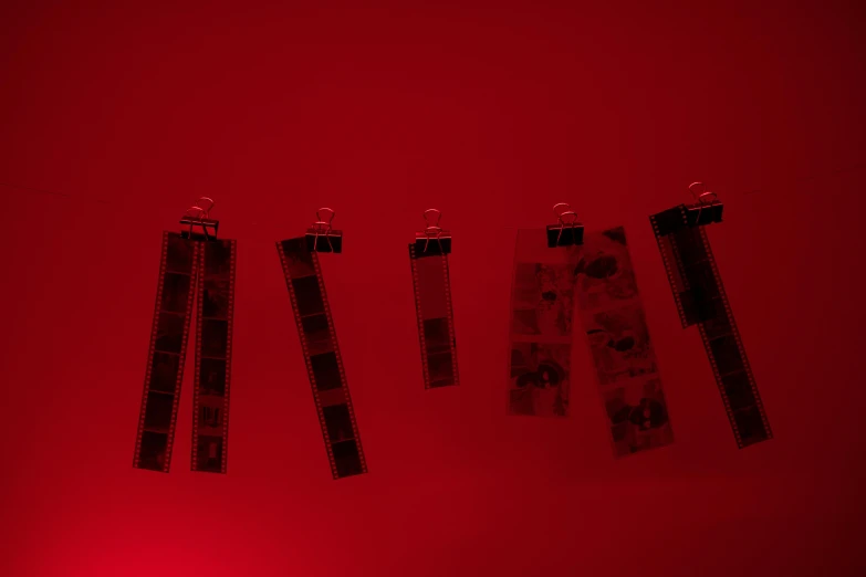 a group of scissors hanging on a red wall, a picture, unsplash, serial art, cinemathic lights, photocopied, small red lights, transparencies