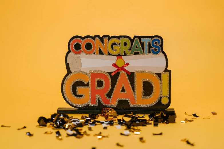 a congratulations sign sitting on top of a pile of confetti, pexels contest winner, academic art, yellow backdrop, 3/4 front view, laser cut, aincrad