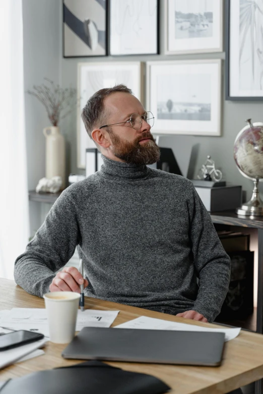 a man sitting at a desk in front of a laptop computer, inspired by Hallsteinn Sigurðsson, wearing turtleneck, grey, most respected design, at home