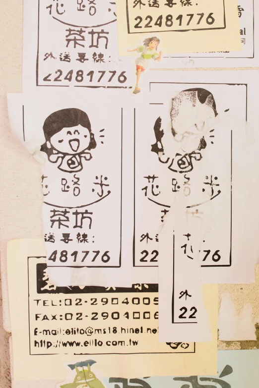 a bunch of stickers that are on a wall, by Tsubasa Nakai, mail art, chinese girl, service ticket close up, with two characters, low quality photo