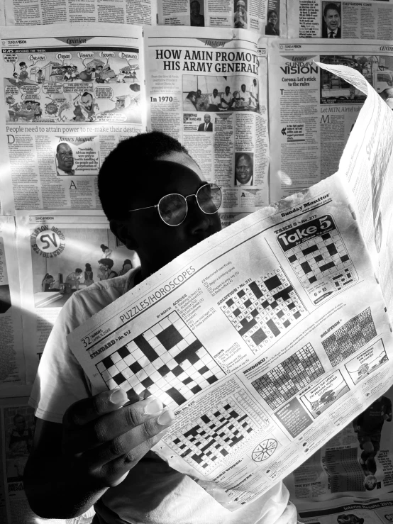 a black and white photo of a man reading a newspaper, a black and white photo, pexels contest winner, visual art, squares, aida muluneh, 1 9 9 3 photo from life magazine, instagram post