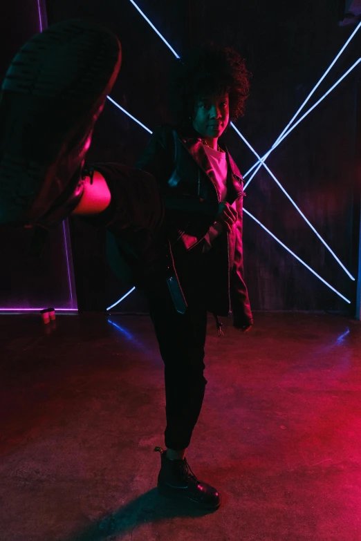 a person standing in a room with neon lights, dramatic wielding gun pose, with afro, doing a kick, wearing urban techwear