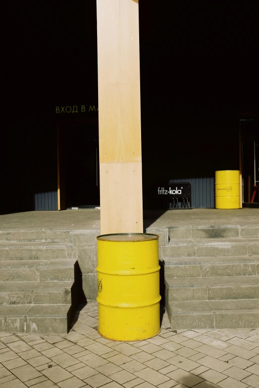 a yellow barrel sitting next to a yellow fire hydrant, an album cover, by Doug Ohlson, conceptual art, wooden structures, opposite the lift-shaft, ((monolith)), hoog detail