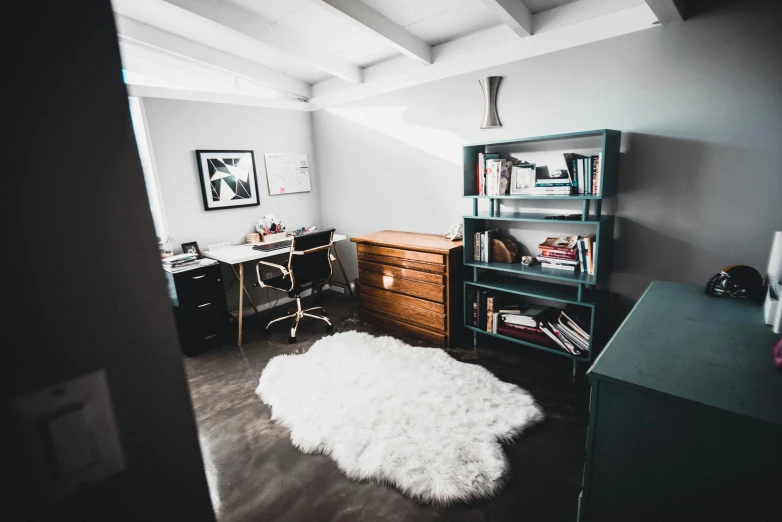 a white rug sitting on top of a hard wood floor, by Julia Pishtar, pexels contest winner, multiple desks, small bedroom, snapchat photo, small library