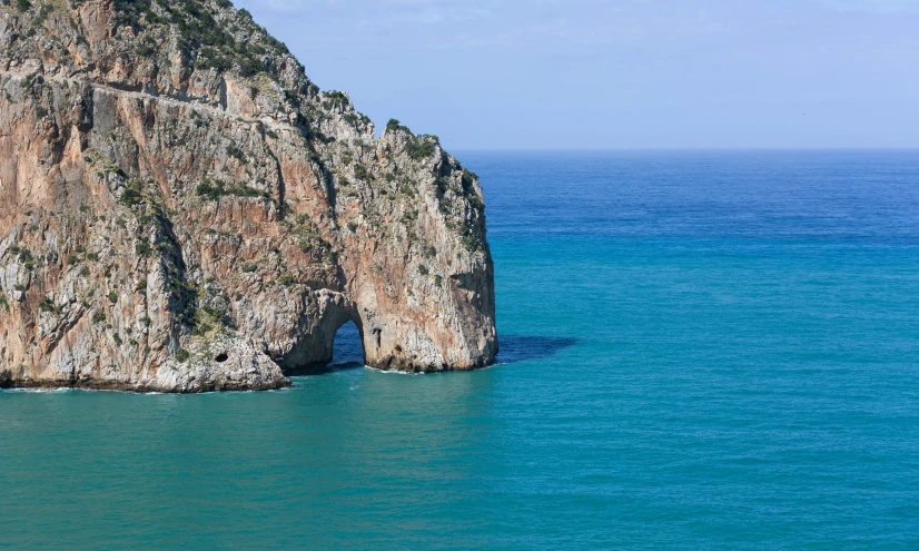 a large rock formation in the middle of the ocean, by Francesco Furini, pexels contest winner, renaissance, picton blue, an archway, 2 5 6 x 2 5 6 pixels, zoomed out view