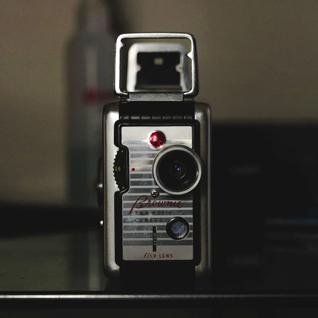 a close up of a camera on a table, collectible, icon, filmatic, low - light photography
