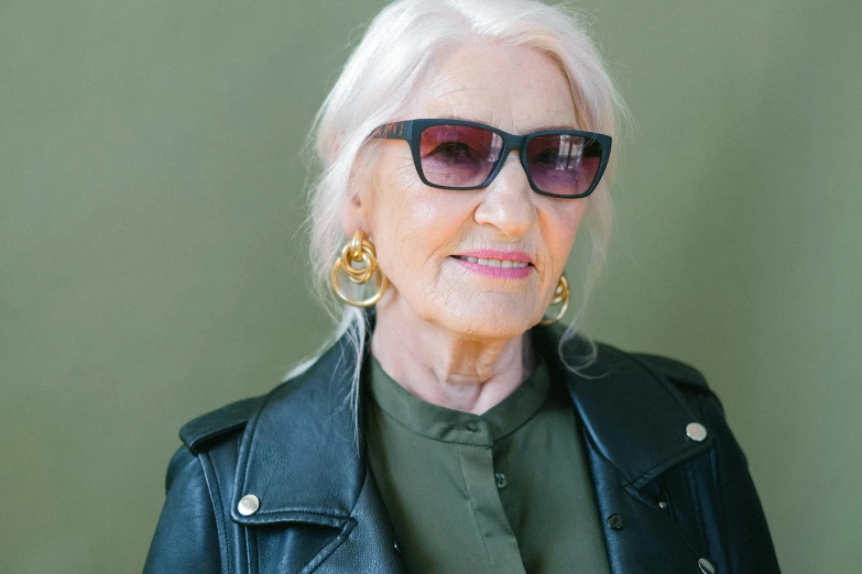 an older woman wearing sunglasses and a leather jacket, by Gavin Hamilton, trending on pexels, square rimmed glasses, may gibbs, with long white hair, basil gogos