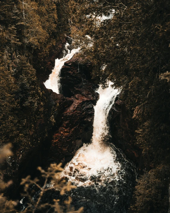 a waterfall in the middle of a forest, an album cover, by Jesper Knudsen, pexels contest winner, hurufiyya, thumbnail, brown water, high quality photo, two stories