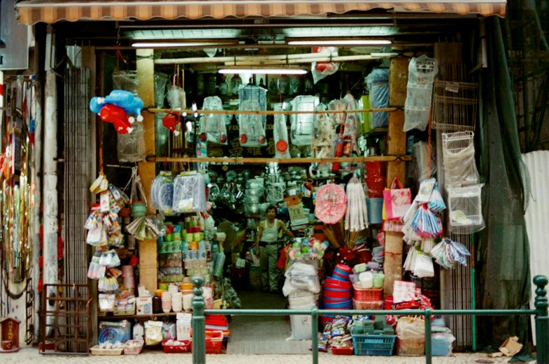 a store with lots of items in front of it, a photo, by Konrad Witz, flickr, cloisonnism, kodak portra 400, phuoc quan, plastic and fabric, hong kong