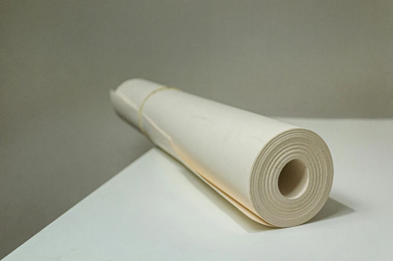 a roll of paper sitting on top of a table, ecru cloth, detailed product image, cotton fabric, ffffound