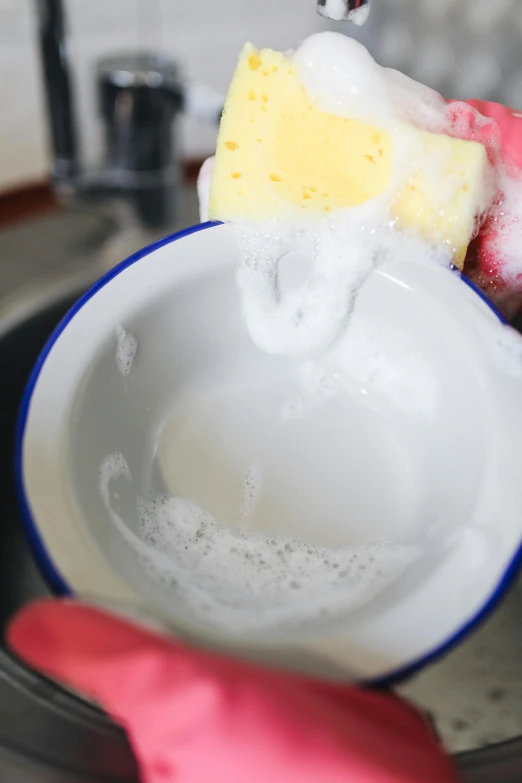 a person washing a dish with a sponge, by Doug Ohlson, unsplash, square, small, cast, made of liquid