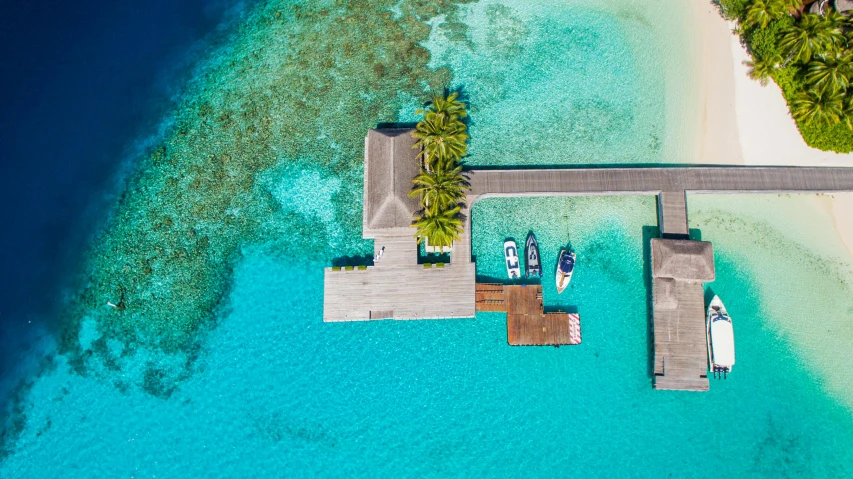 a couple of boats sitting on top of a body of water, a screenshot, pexels contest winner, hurufiyya, maldives in background, bird's view, a man sitting on a jetty, next to a tropical pool