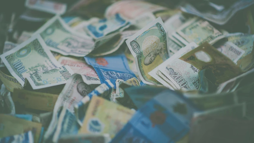 a pile of money sitting on top of a table, trending on unsplash, mingei, faded colors, promo image, thumbnail, lo - fi colors