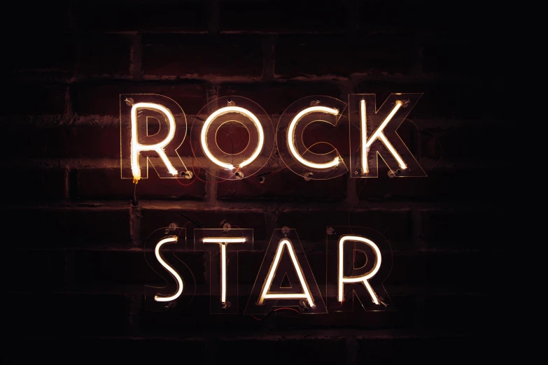 a neon sign that says rock star on a brick wall, an album cover, by Julia Pishtar, shutterstock, northern star at night, oscar winning, the band name is roborock, rugged | stars