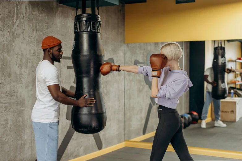 a man and a woman boxing in a gym, pexels contest winner, holding a gold bag, 😭🤮 💔, profile image, round format