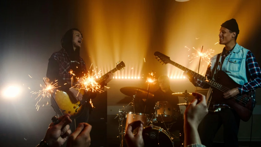 a group of people that are holding sparklers, by Gavin Nolan, pexels contest winner, conceptual art, playing a gibson les paul guitar, 2 0 2 1 cinematic 4 k framegrab, still from alita, three point lighting bjork
