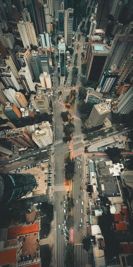 an aerial view of a city with tall buildings, an album cover, by Patrick Ching, pexels contest winner, avenida paulista, unsplash 4k, instagram story, streets