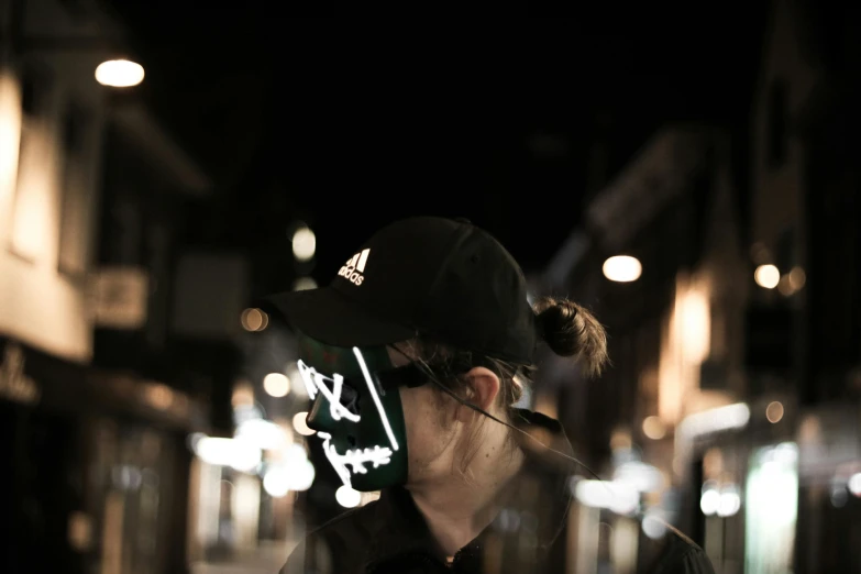 a close up of a person on a cell phone, unsplash, graffiti, glowing visor, wearing bandit mask, very dark with green lights, trending on r/streetwear