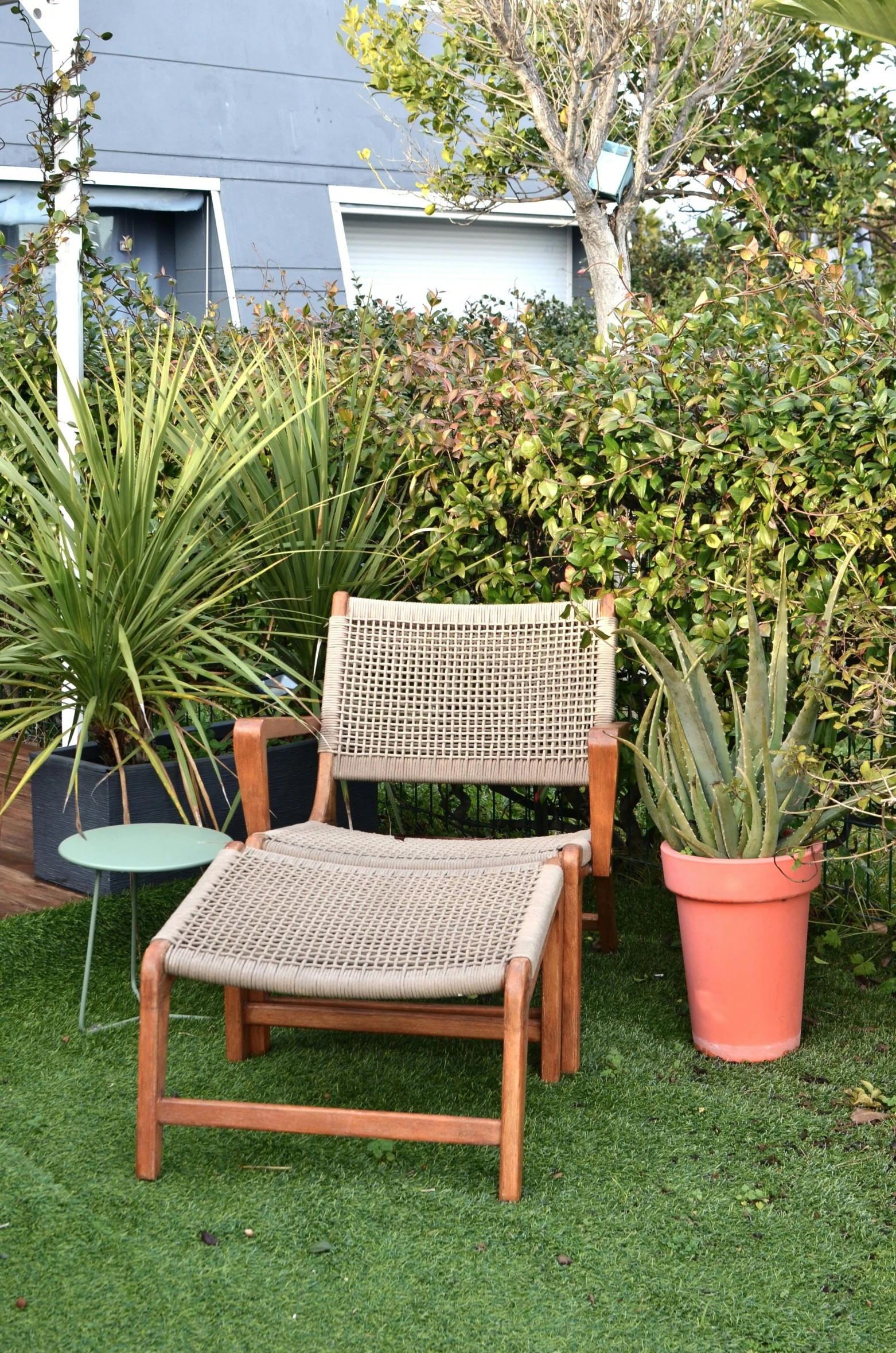 a chair that is sitting in the grass, roof garden, manly, with soft bushes, webbing