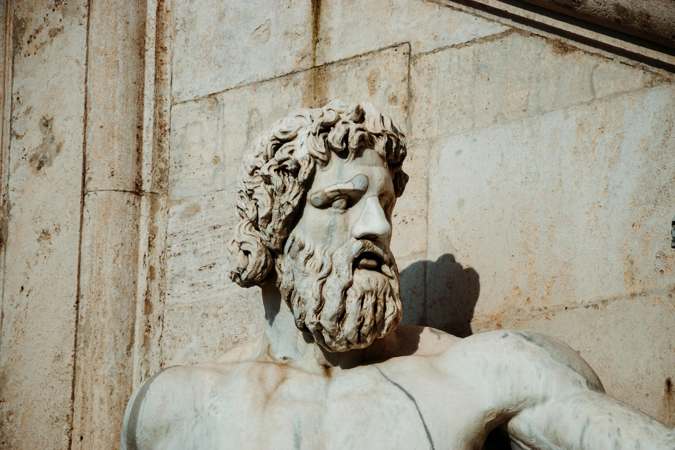 a statue of a man with a beard, a marble sculpture, inspired by Exekias, pexels contest winner, square masculine jaw, 1 2 9 7, donato, tourist photo