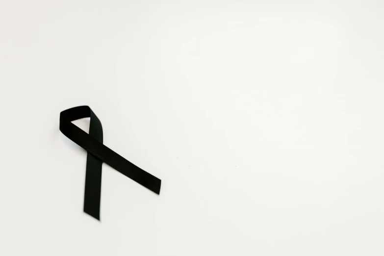 a black ribbon on a white background, by Emma Andijewska, pexels, hurufiyya, the cure for cancer, instagram picture, remembering his life, an alien