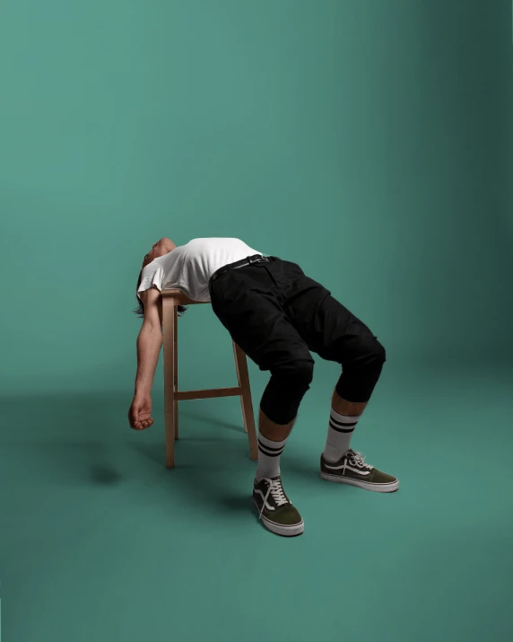 a man sitting on top of a wooden chair, by James Morris, pexels contest winner, sprawled out, jacksepticeye, sleepy feeling, 15081959 21121991 01012000 4k