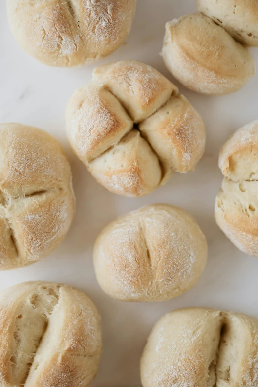 a bunch of bread rolls sitting on top of a table, inspired by Richmond Barthé, light tan, mediterranean, vanilla, petite