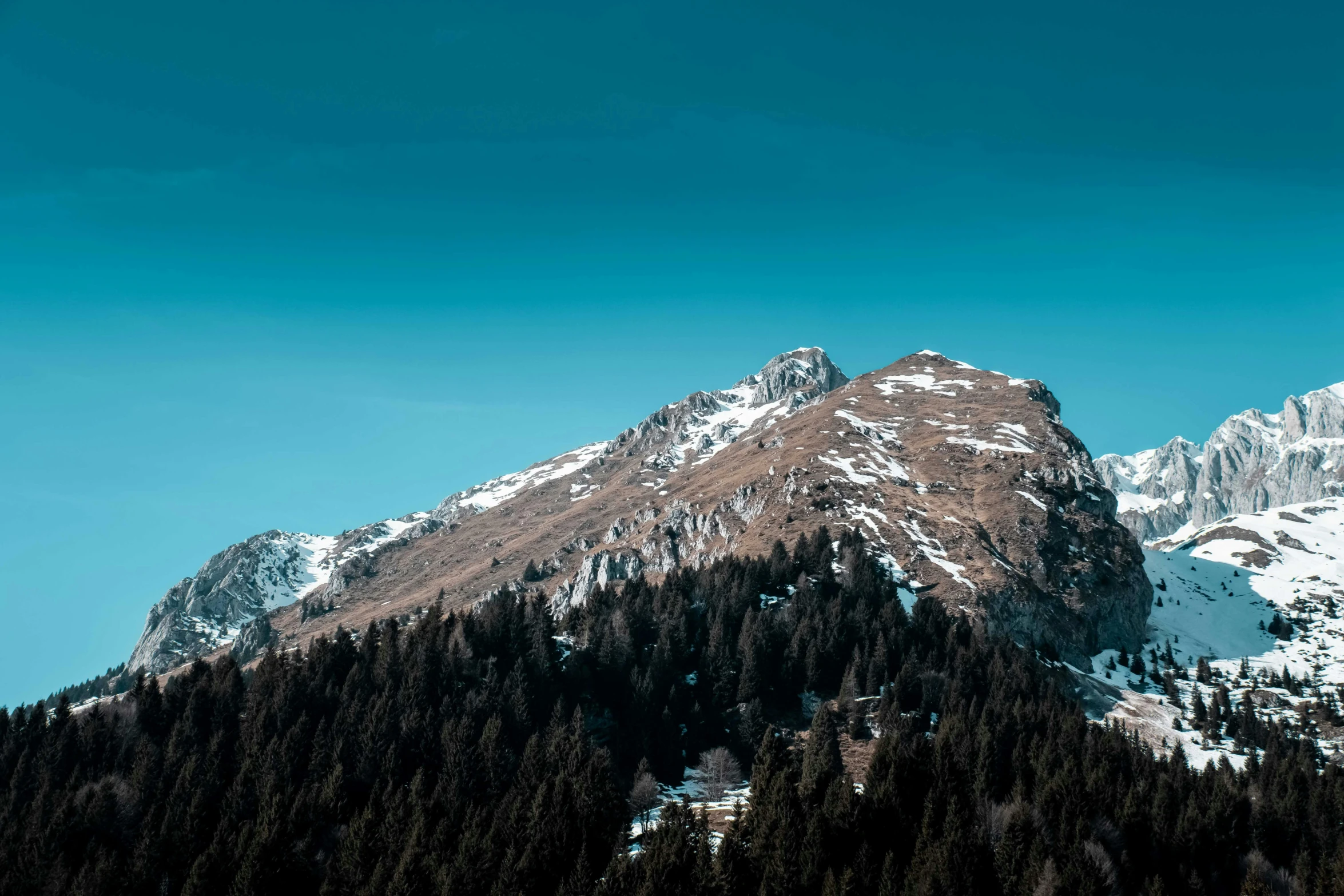 a snow covered mountain with pine trees in the foreground, pexels contest winner, les nabis, clear blue sky, thumbnail, 4 k hd wallpapear, minimalist photo