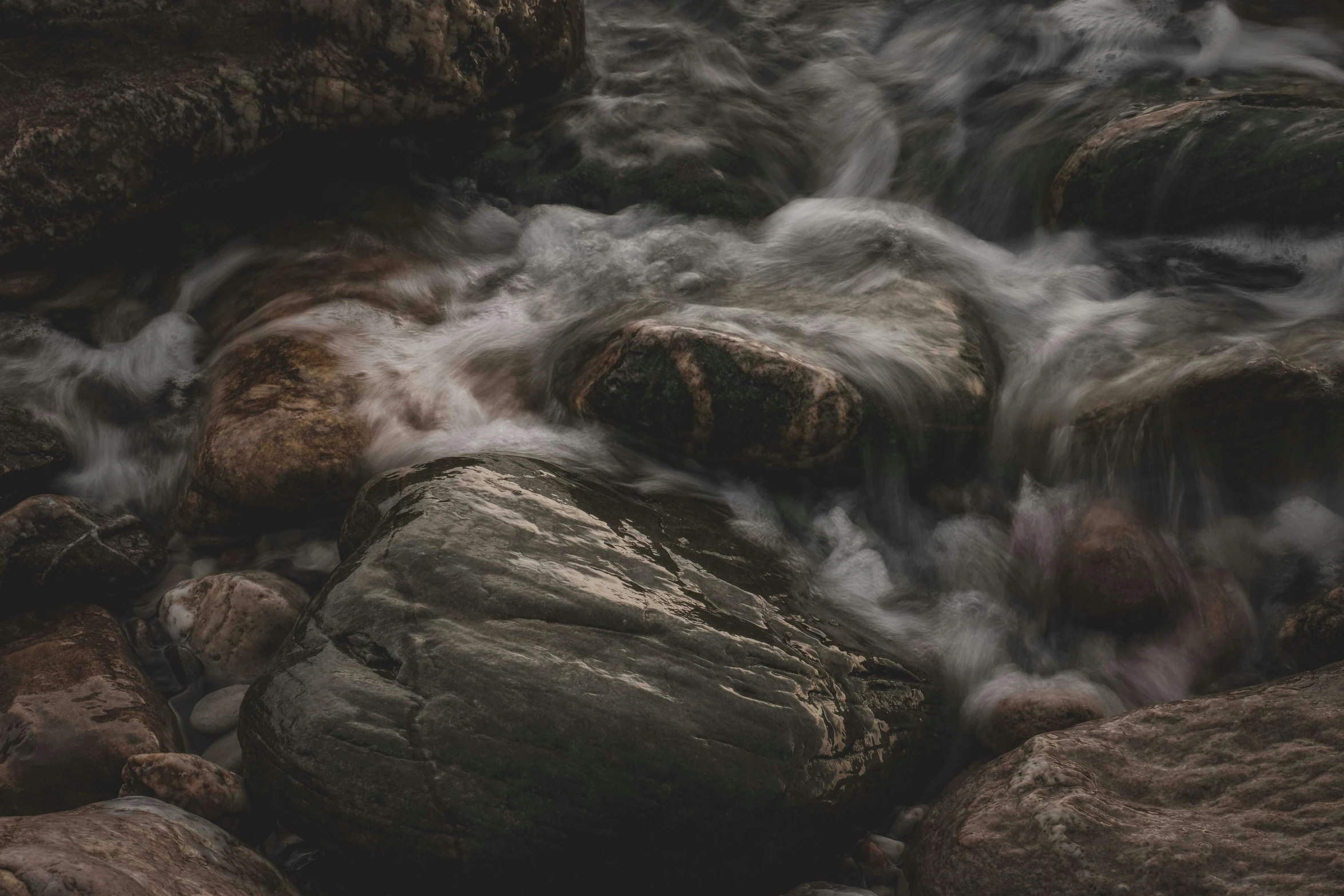 a group of rocks sitting on top of a river, inspired by Elsa Bleda, unsplash contest winner, tonalism, rushing water, grey, 4 k smooth, brown