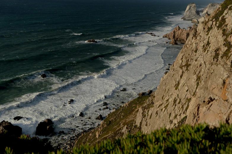 a view of the ocean from the top of a cliff, by Xavier Blum Pinto, pexels contest winner, bispo do rosario, grey, late afternoon, thumbnail