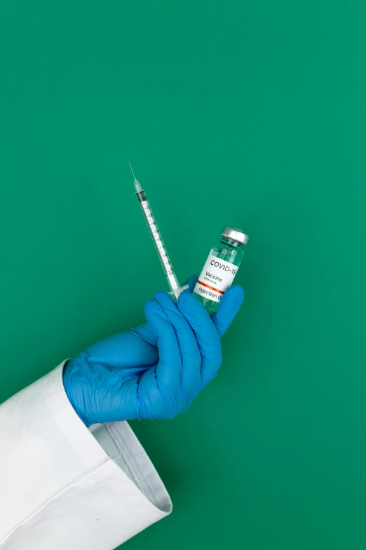 a person in a lab coat holding a syet, an album cover, shutterstock, holding syringe, teal aesthetic, instagram post, a green