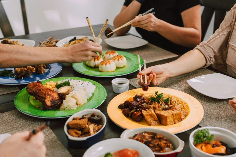 a group of people sitting at a table with plates of food, pexels contest winner, mingei, bao pham, family friendly, lachlan bailey, meaty