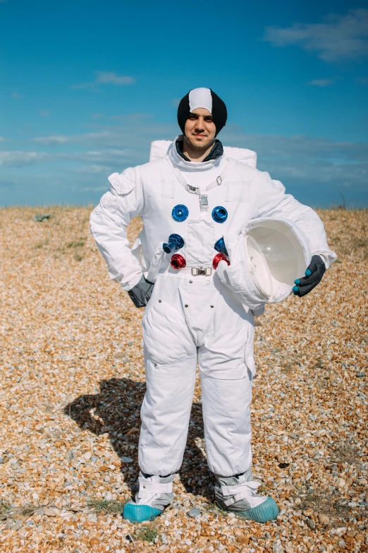 a man in an astronaut suit standing on a beach, wearing seashell attire, liam brazier, outside in space, wearing dirty travelling clothes