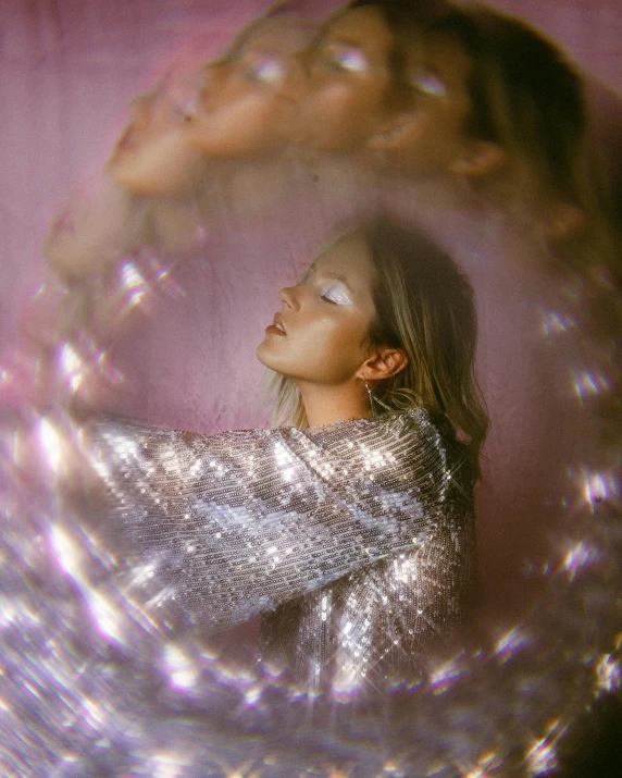 a close up of a woman in a silver dress, trending on pexels, holography, soap bubble, sydney sweeney, looking through a portal, she is in pure bliss
