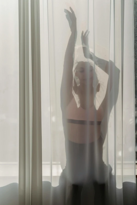 a woman that is standing in front of a window, an album cover, unsplash, conceptual art, miley cyrus, soft translucent fabric folds, translucent body, courtesy of moma