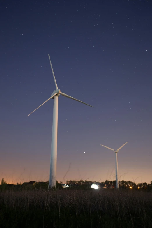 three wind turbines in a field at night, a portrait, unsplash, full frame image, trending photo, sprawling, mill