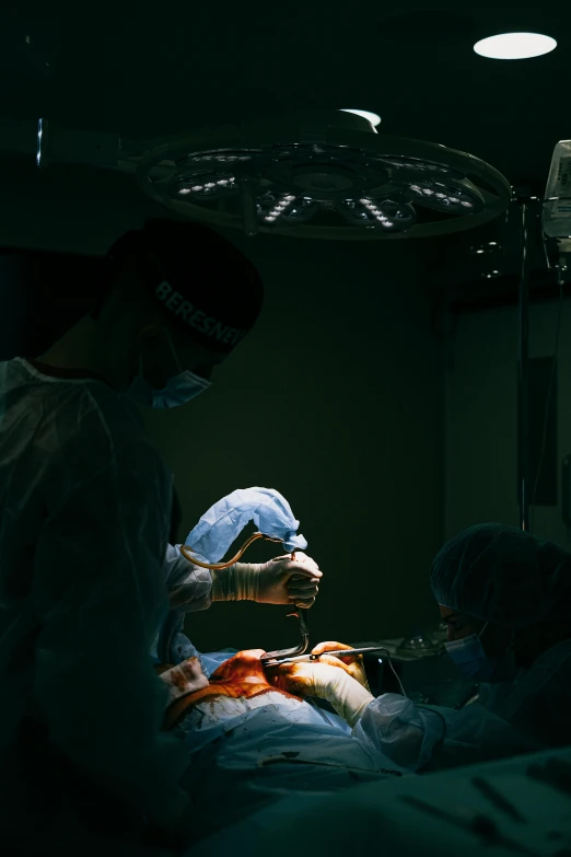 a group of surgeons performing surgery on a patient, an album cover, by Adam Marczyński, pexels contest winner, back light, high quality photo, multiple stories, cinematic-shot