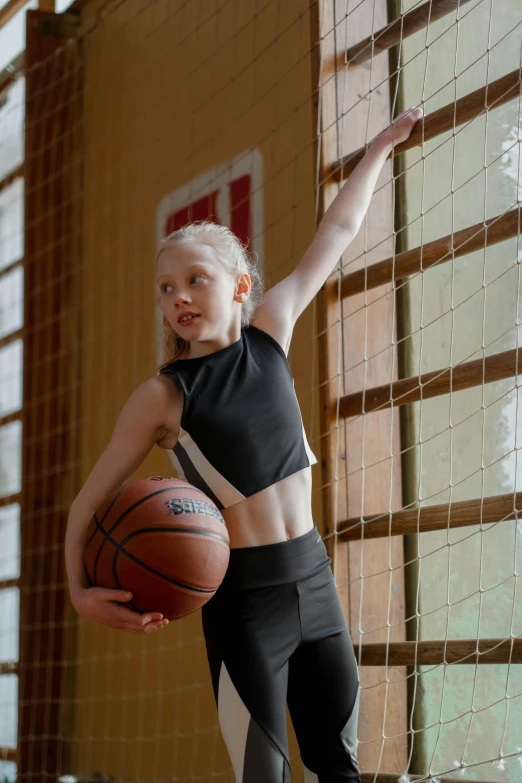 a woman standing on a basketball court holding a basketball, by Greg Spalenka, trending on dribble, girl with plaits, wearing leotard, nadezhda tikhomirova, youth