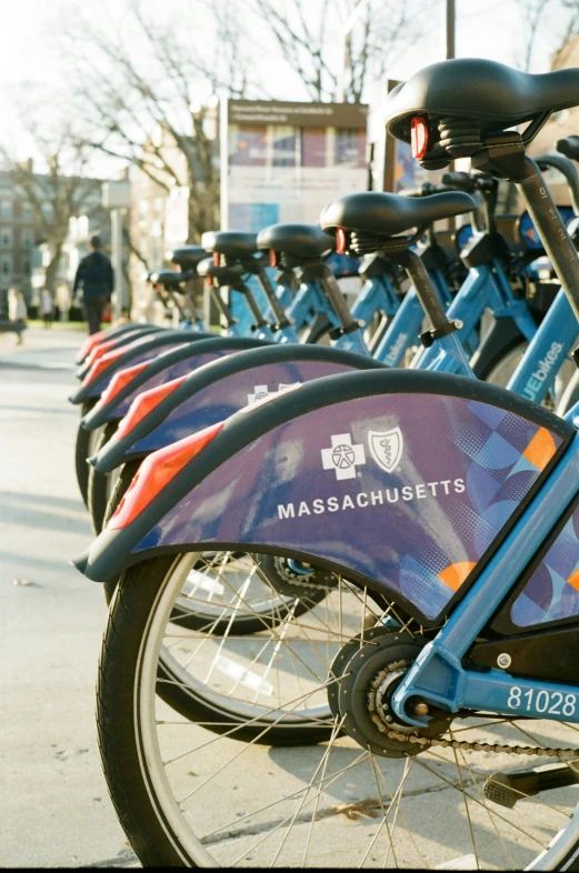 a row of bicycles parked on the side of a street, inspired by Washington Allston, unsplash, happening, blue and purple scheme, 3/4 front view, close - up profile, boston