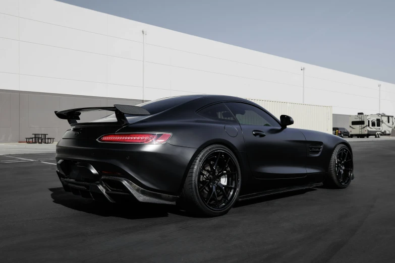 a black mercedes sports car parked in a parking lot, inspired by Otto Abt, thicc build, with his back turned, alterd carbon, “ full body