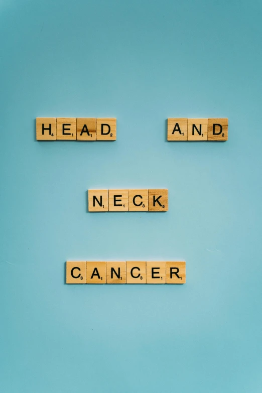 scrabbles spelling head and neck cancer on a blue background, by Eglon van der Neer, around a neck, 64x64, photograph taken in 2 0 2 0, may)