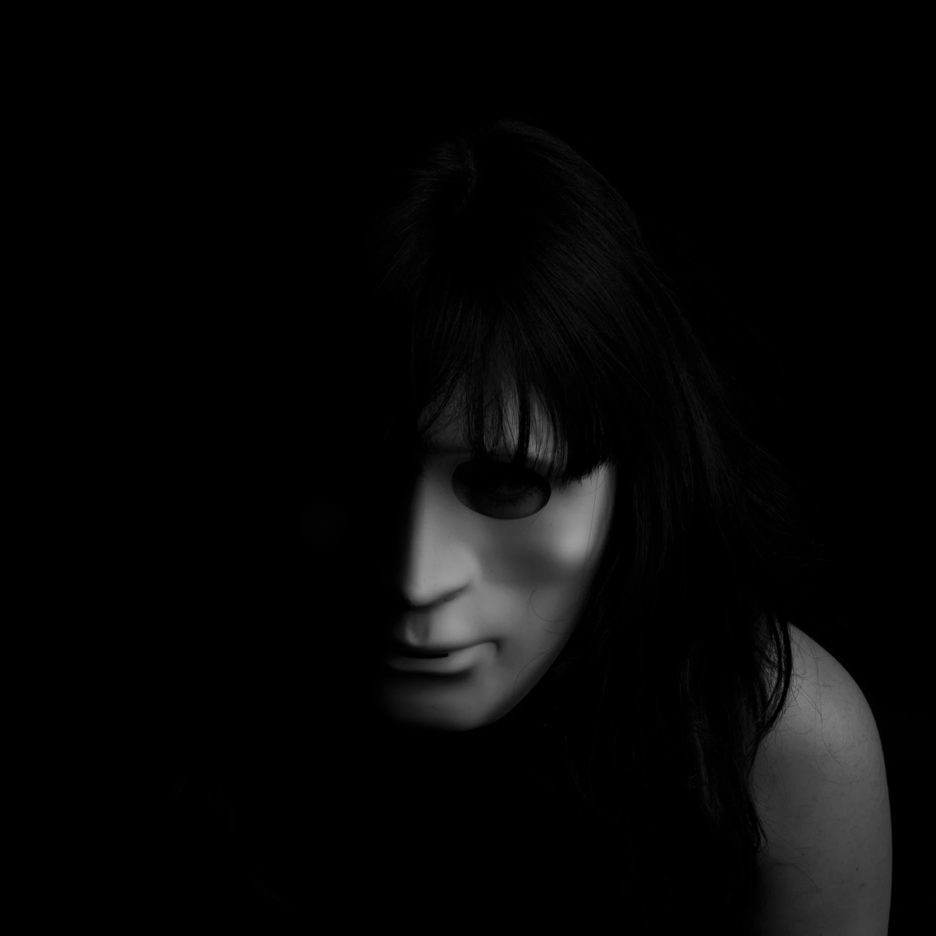 a black and white photo of a woman in the dark, an album cover, inspired by Gottfried Helnwein, pexels contest winner, conceptual art, black bangs, portrait of a humanoid alien, portrait of male humanoid, black eyed