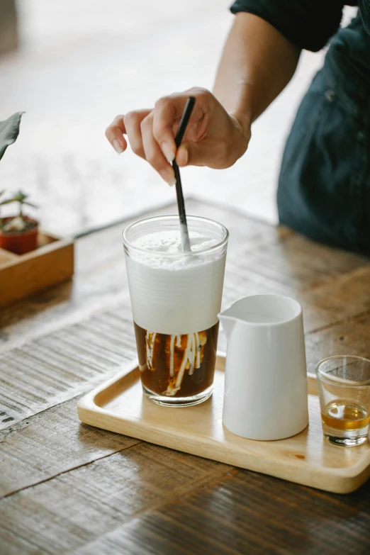 a person sitting at a table with two cups and a spoon, cold brew coffee ), japanese collection product, layer upon layer, thumbnail