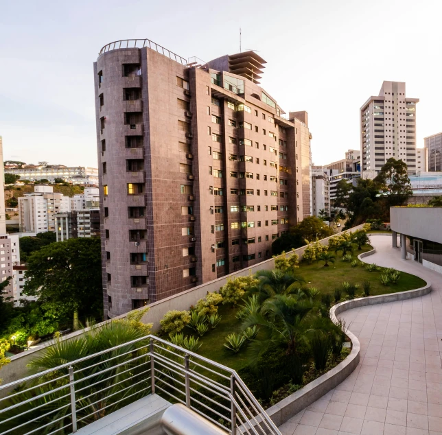 a view of a city from the top of a building, by Felipe Seade, brutalism, exterior botanical garden, upscale photo