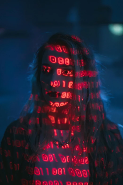 a woman with a red light on her face, pexels contest winner, ascii art, covered in runes, obscured face, mid shot photo, cyber school girl