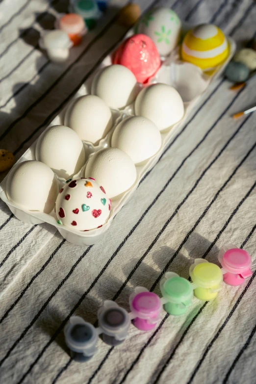 a tray of eggs sitting on top of a table, an airbrush painting, candy decorations, overglaze, product shot, hearts