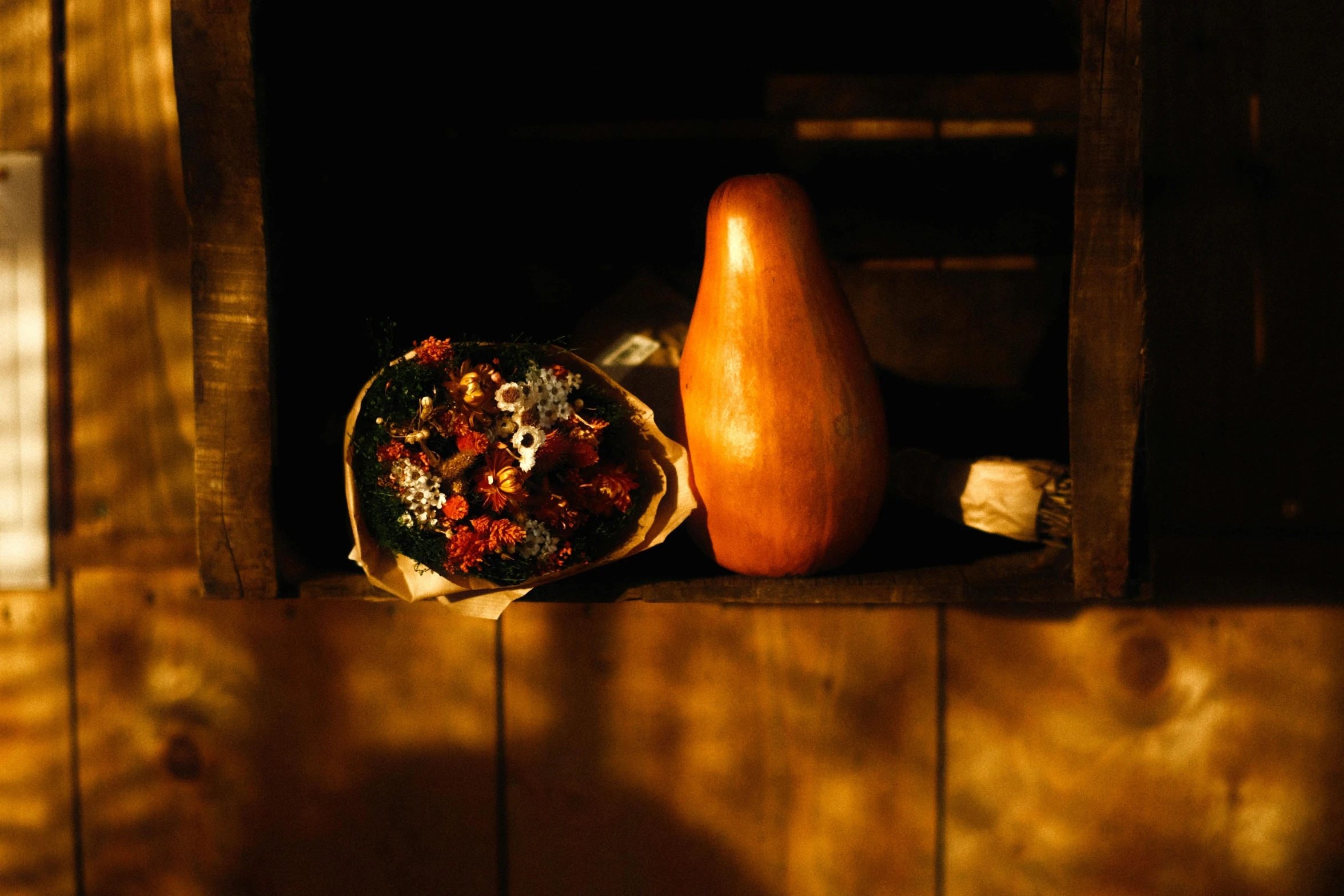 a vase sitting on top of a wooden shelf next to a window, a still life, unsplash, renaissance, gourds, berries inside structure, fire lit, made of flowers and berries