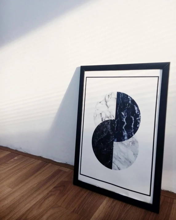 a black and white picture sitting on top of a wooden floor, poster art, inspired by Wang Duo, unsplash, geometric abstract art, blue marble, yinyang shaped, framed poster, inside a marble