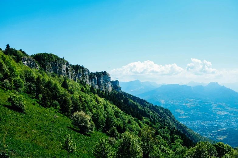 a view of the mountains from the top of a hill, by Cedric Peyravernay, pexels contest winner, les nabis, green and blue, traveling in france, view from side, thumbnail